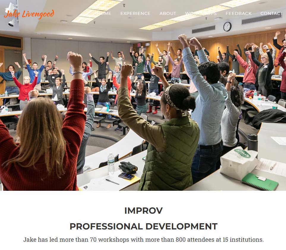 Image of Jake Livengood's web page where there are people in the classroom who are standing with their arms raised.